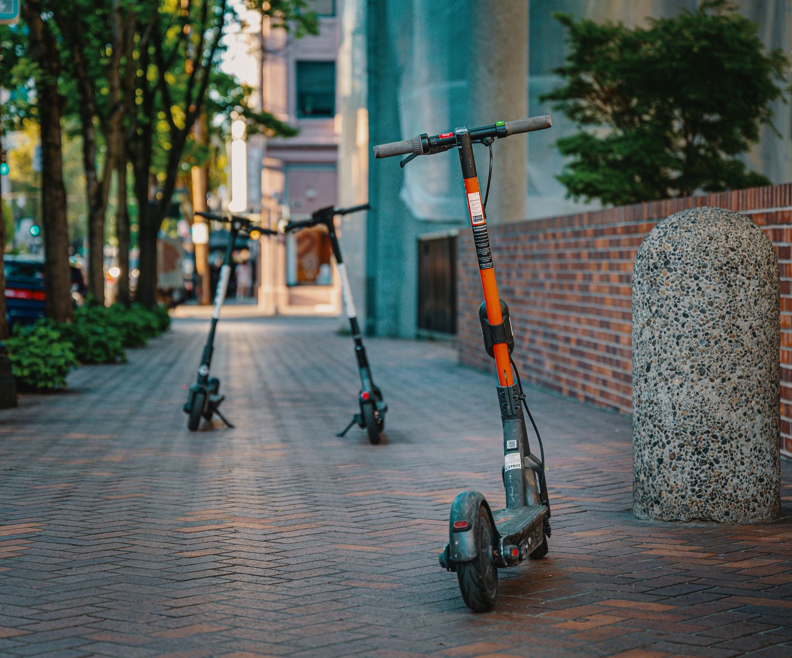 Patinetes elétricos estacionados em uma calçada urbana, representando uma opção de mobilidade nas cidades.